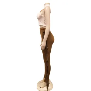 Side view of two-piece set featuring pink sleeveless crop top and brown fringe leggings