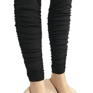 Gros plan sur un legging noir à volants plissés avec une texture empilée élégante