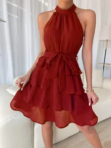 Detailed view of dark red sleeveless halter dress with tiered ruffled hemline