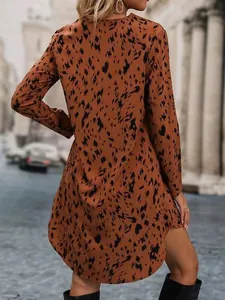 Back view of a chic leopard print long-sleeved dress for women in a street setting