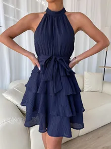 Close-up of elegant navy blue sleeveless halter neck tiered ruffle summer dress for women