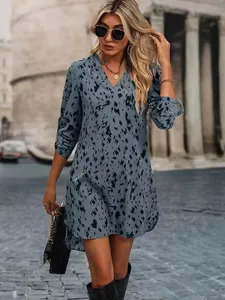 Close-up of stylish blue leopard print fabric and V-neckline detail on a women's dress.
