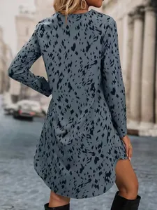 Back view of blue leopard print long-sleeved shirt dress in street setting