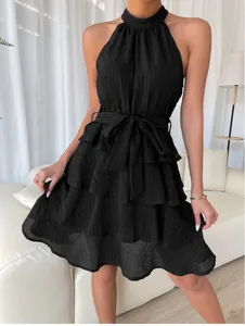 Close-up of black sleeveless halter neck dress with ruffled layers
