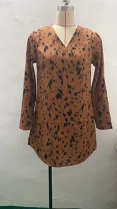 Detailed view of a brown leopard print long sleeve dress with V-neckline on a mannequin