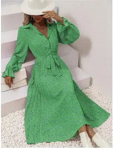 Detailed view of a green floral pleated long sleeve maxi dress with a stylish waist tie