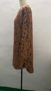 Side view of leopard print long-sleeved dress with stand collar detail on mannequin