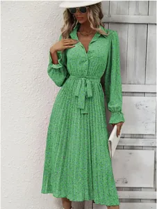 Elegant green floral pleated midi dress with long sleeves and tie waist detail