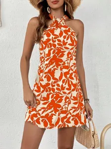 Detail of vibrant orange floral halter neck sleeveless mini dress for summer vacation
