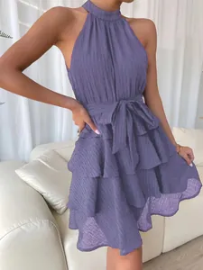 Detail view of purple sleeveless halter neck dress with ruffled tiers and waist tie