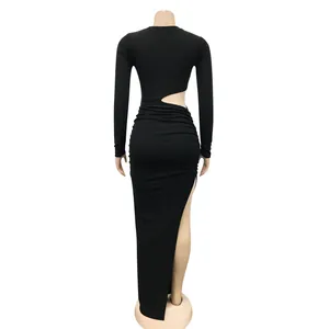 Back view of a black long-sleeved maxi dress featuring a waist cutout and high side slit