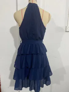 Back view of navy blue tiered sleeveless dress with ruffle layers on mannequin