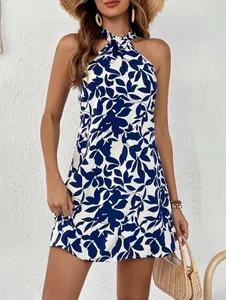 Elegant detail view of a blue and white leaf print halter sleeveless dress on a model