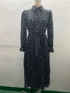 Detailed view of floral pleated long sleeve maxi dress with waist tie on mannequin