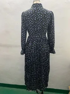 Back view of vintage floral pleated long-sleeved maxi dress featuring collar and ruffles.