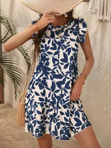 Detailed view of casual blue leaf print dress styled with a straw hat and bag.