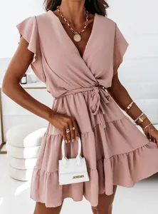 Elegant pink V-neck mini dress featuring ruffle sleeves, a tie-waist, and tiered skirt.