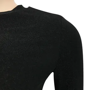 Close-up detail showing the shimmering black knit fabric on a long sleeve dress shoulder.