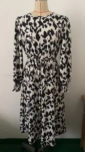 Detailed view of black and white abstract print long sleeve dress on mannequin display