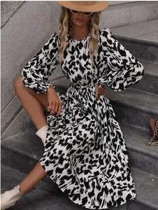 Close-up detail of a stylish black and white leopard print maxi dress with long sleeves