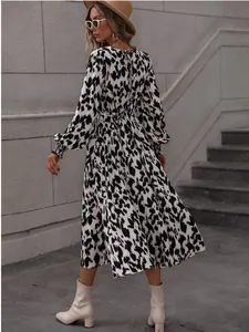 Elegant black and white leopard print long sleeve maxi dress with tie waist detail view