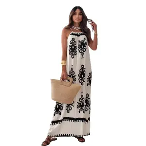 Elegant white halter maxi dress with black floral print and backless design for summer.