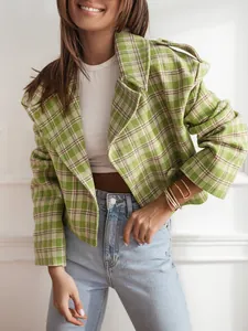 Close-up of a stylish green plaid wool blend cropped blazer with notched lapels