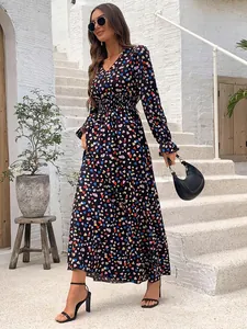 Model wearing a stylish V-neck long-sleeve maxi dress with colorful heart print details