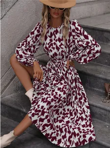 Detailed view of long-sleeved leopard print maxi dress featuring a waist tie detail