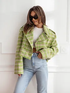 Fashionable green plaid cropped woolen jacket shown on a model with white wall background