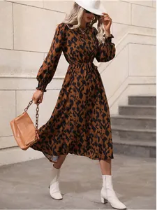 Detail of leopard print long sleeve maxi dress with tied waist and elastic cuffs