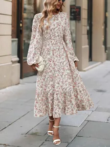 Close-up detail of a floral print long sleeve maxi dress with elegant ruffled hemline