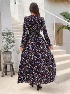 Detail showing back profile of the printed maxi dress with smocked waist and tiered skirt flow