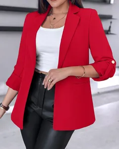 Detail view of vibrant red women's blazer with buttoned rolled sleeves design.