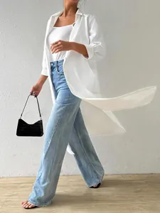 Stylish white long cardigan shirt and blue wide-leg jeans shown in a walking pose