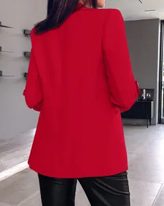Rear view of vibrant red blazer featuring stylish ruched sleeves and a tailored fit