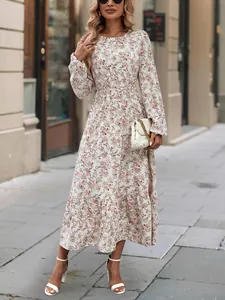 Elegant floral print long sleeve tiered maxi dress with ruffle hem shown on street