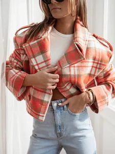 Detail view of a stylish red plaid wool jacket with classic lapel and shoulder tabs.