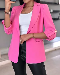 Detailed view of stylish hot pink women's blazer featuring buttoned rolled sleeves for fall