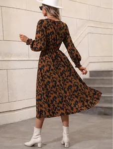 Back view of leopard print long-sleeve midi dress with elastic cuffs and waist tie