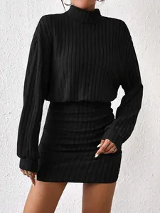 Elegant black ribbed turtleneck bodycon dress with long sleeves shown on a fashion model.