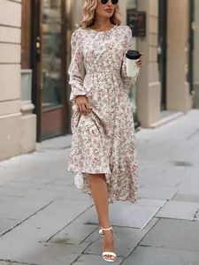Detailed shot of a floral print midi dress featuring long sleeves and a ruffled hemline