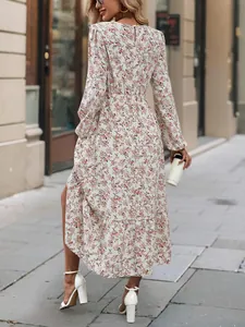Back view of floral print long sleeve dress with ruffle hem and round neck detail