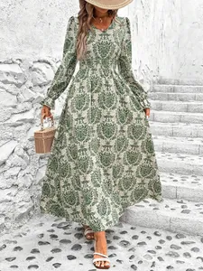 Detail showing the smocked waist and intricate floral patterns of the V-neck maxi dress