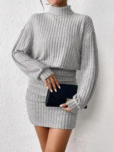 Elegant close-up of a grey ribbed knit high-neck bodycon mini dress with long sleeves