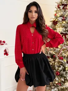 Close-up of red rhinestone long-sleeve shirt and black mini skirt set for women