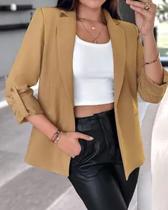 Close-up detail of women's khaki blazer with stylish roll-up sleeve design for fall