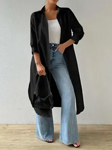 Fashionable long black button-down cardigan shirt for women styled with blue jeans