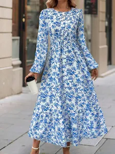 Floral round neck long sleeve maxi dress with ruffled hem shown in outdoor setting