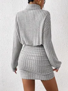 Back view of grey ribbed turtleneck dress with long sleeves and ruched mini skirt